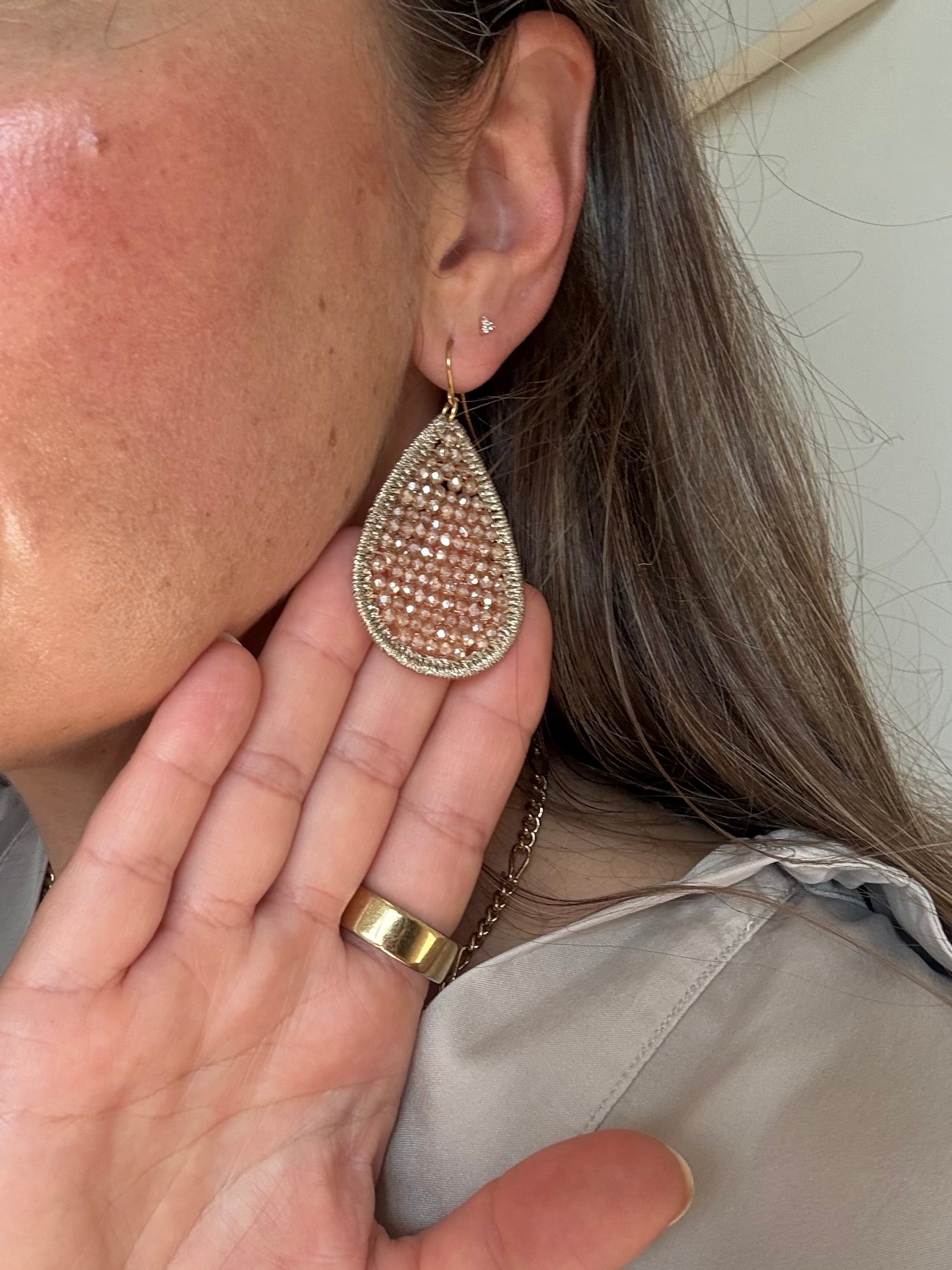 Champagne crystal teardrop earring worn - close up