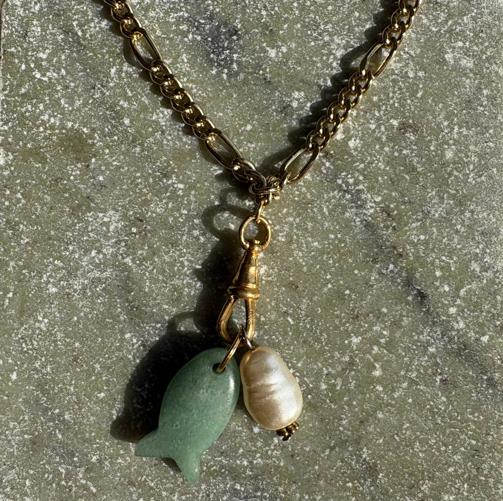 Jade fish and baroque pearl charm detail in sunlight