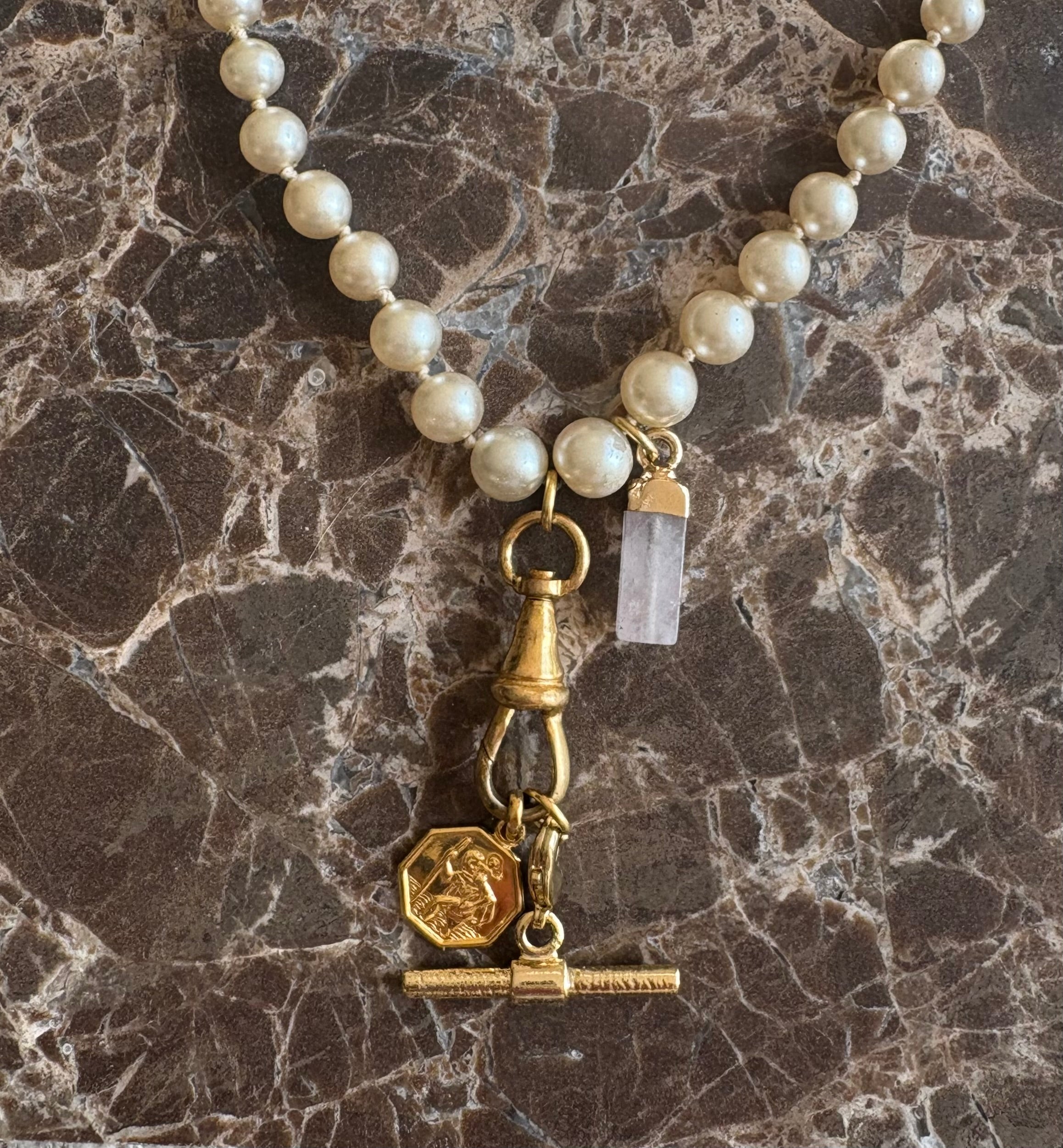 St. Christopher charm and rose quartz point detail