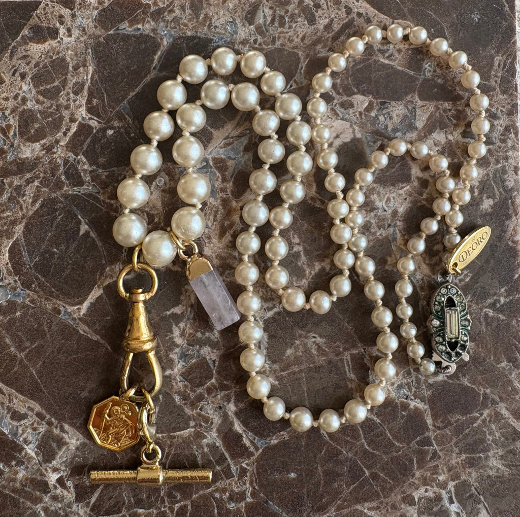 Vintage pearl necklace full length on marble