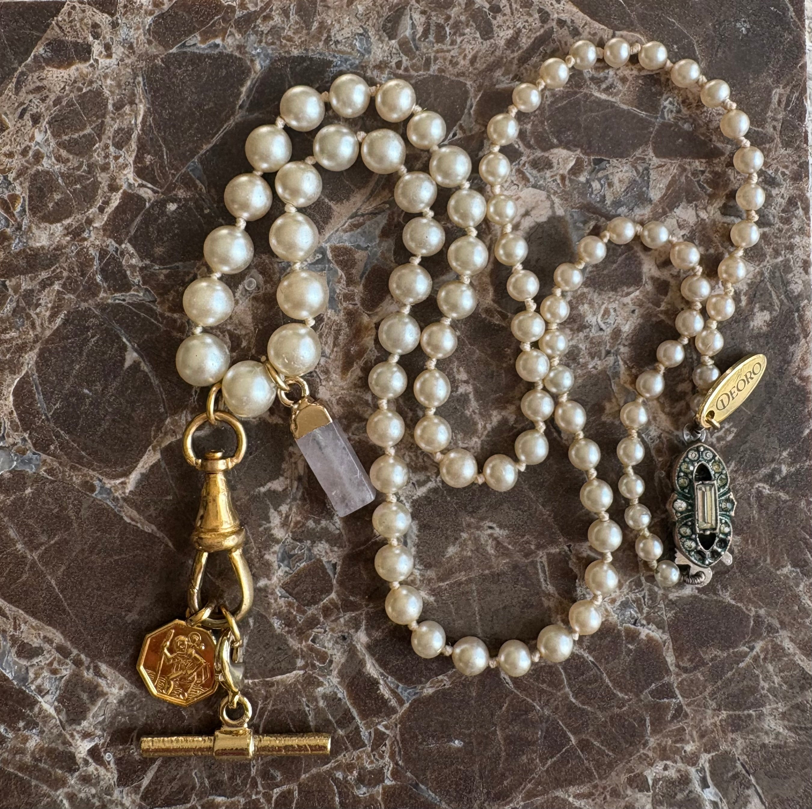 Vintage pearl necklace full length on marble