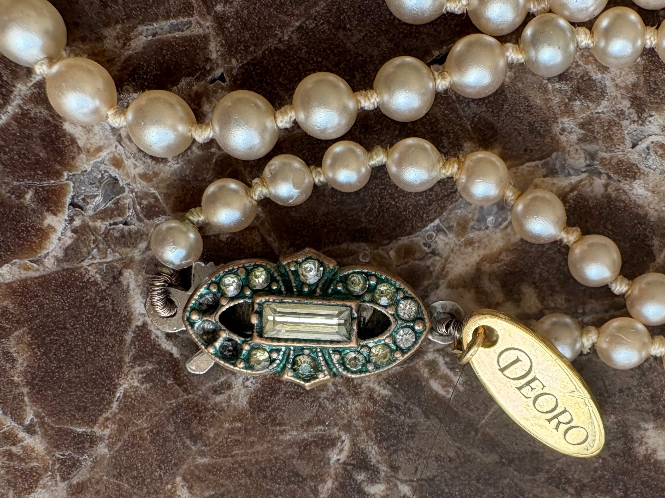 Art Deco rhinestone clasp close up with Deoro tag